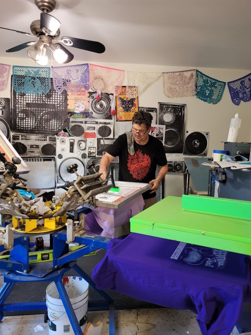 Tom Little of Jeeptrail Print in Chico, California, works with Pedal Press and Julia Murphy to provide mentoring to youth who have an interest in screen printing.